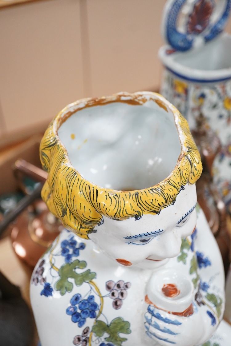A large Brussels style faience Bacchus figural wine cistern, 62cm high